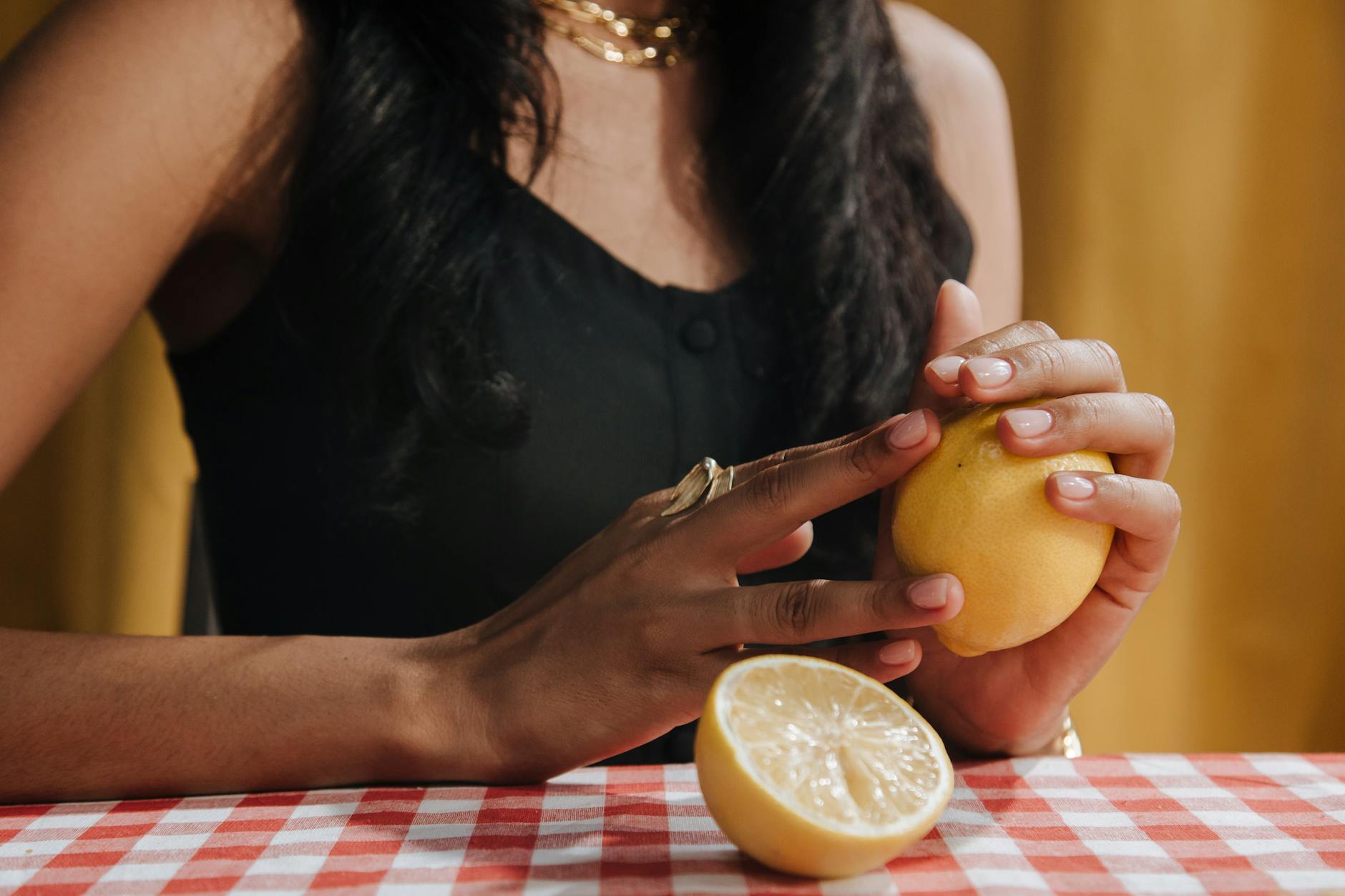 A person holding fresh lemons, symbolizing renewal and the brightening of low-desire phases