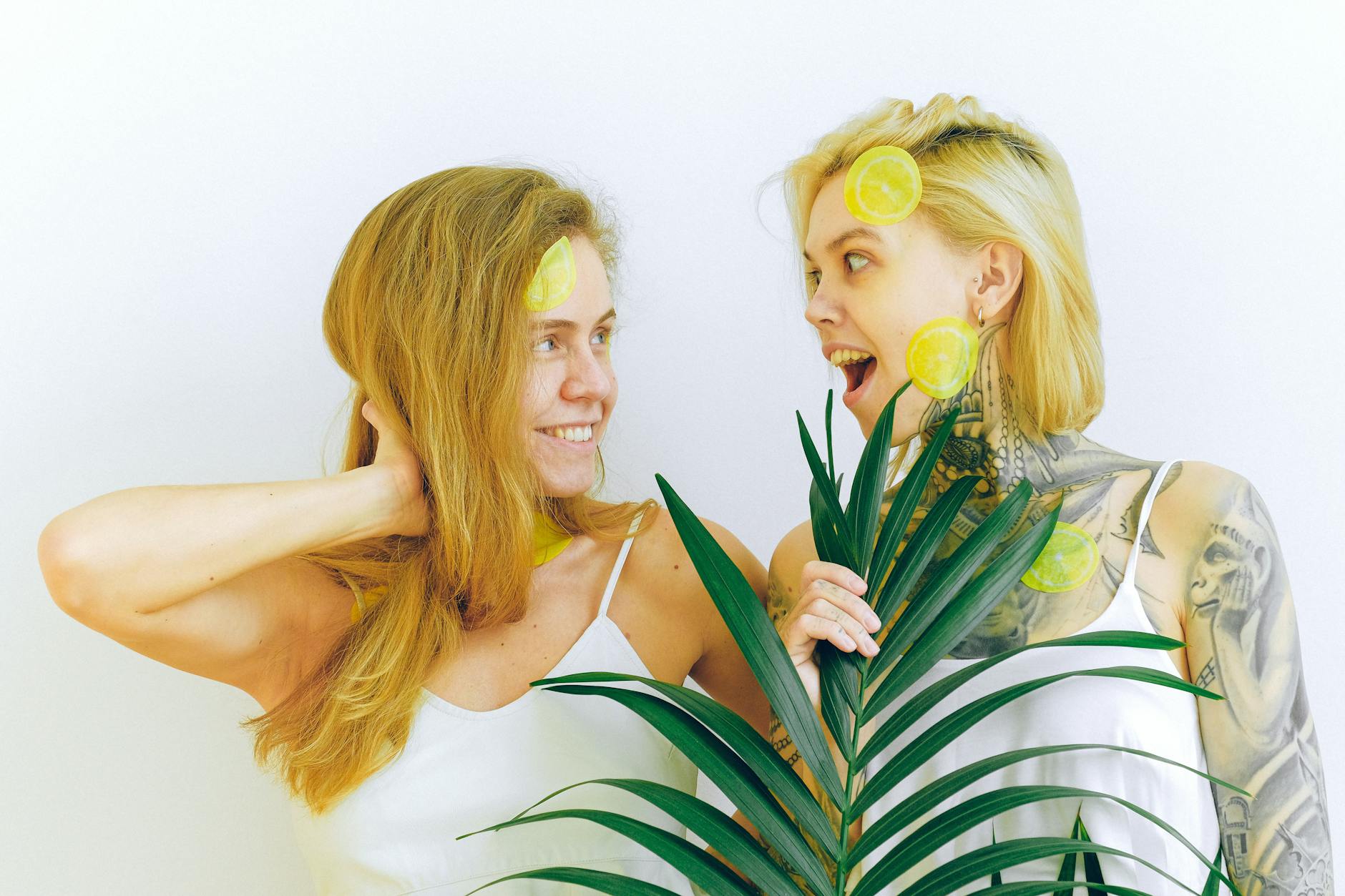 Two women smiling with joy indoors, expressing comfort and connection